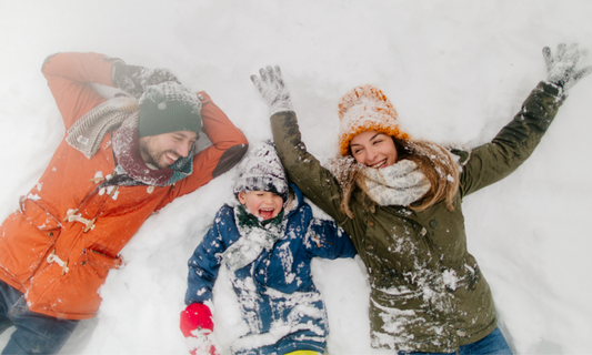 A family enjoying outdoor activity in the snow to help Myopia