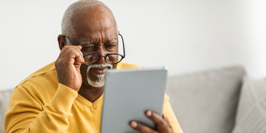 A man suspecting to have Cataracts staring at a book.
