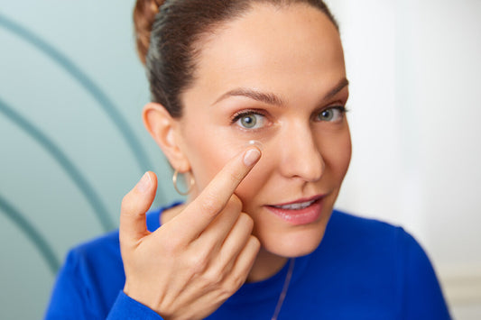 A woman trying to wear contact lenses