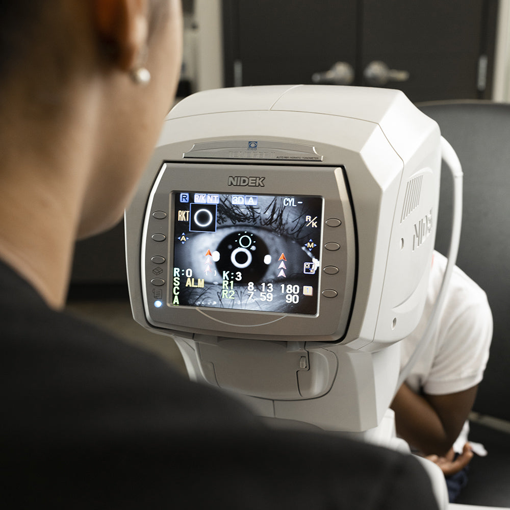 An optometrist carrying out an eye exam on a patient's eye using eye technology