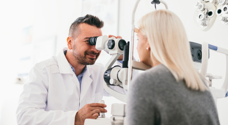 AN eye doctor executing eye exams with the aid of a machine