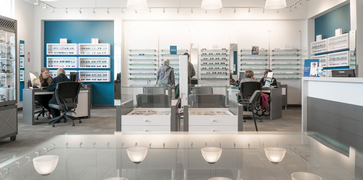 An Fyidoctor clinic with well displayed eyeglasses and patients being attended to by Optometrists