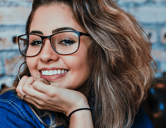 Brunette woman modeling chic eyeglasses