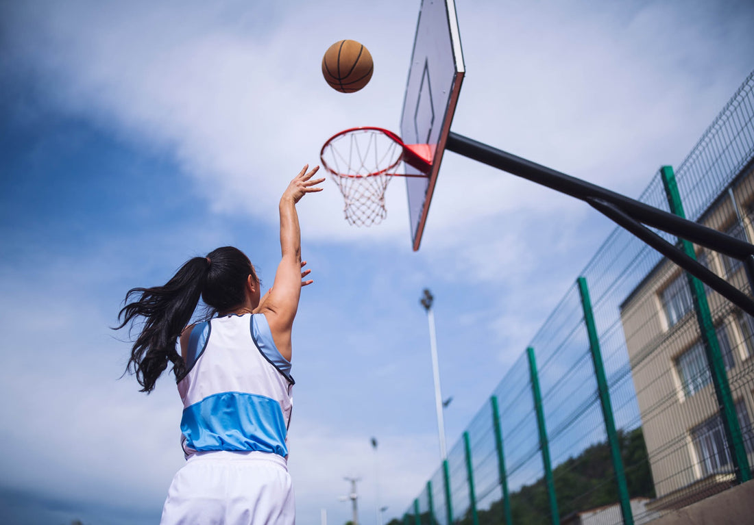 An image of a lady athlete with good eyes playing basketball