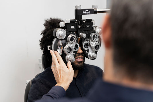 An eye specialist using eye technology to execute an eye exam on a patient