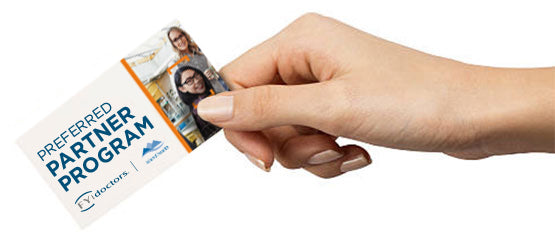 A hand holding out a preferred partnership program card - vision needs