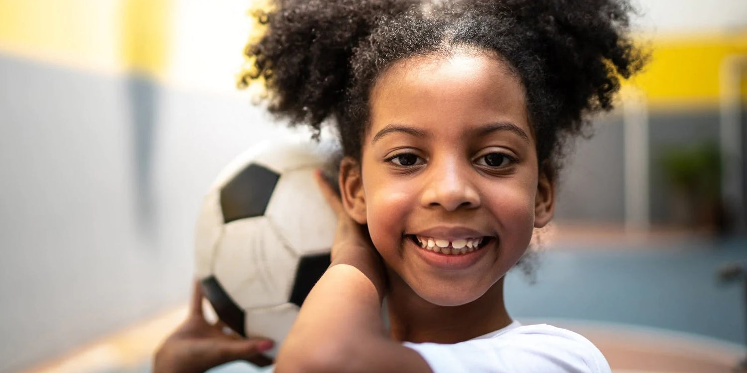 A child exhibiting Myopia holding a ball