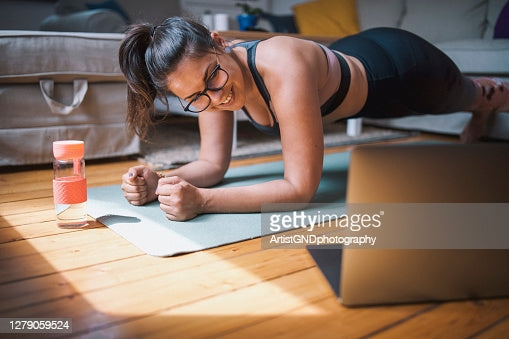 A lady doing exercises with her eye glasses on