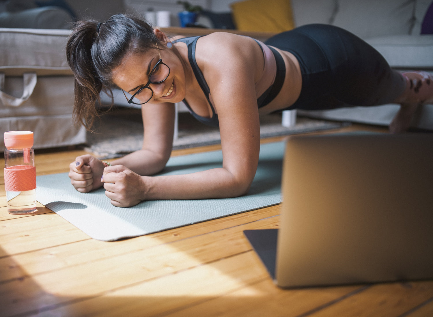 A woman with a pair of glasses doing yoga