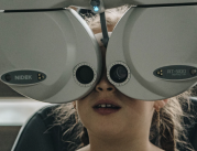 A young girl having her eyes examined using eye technology